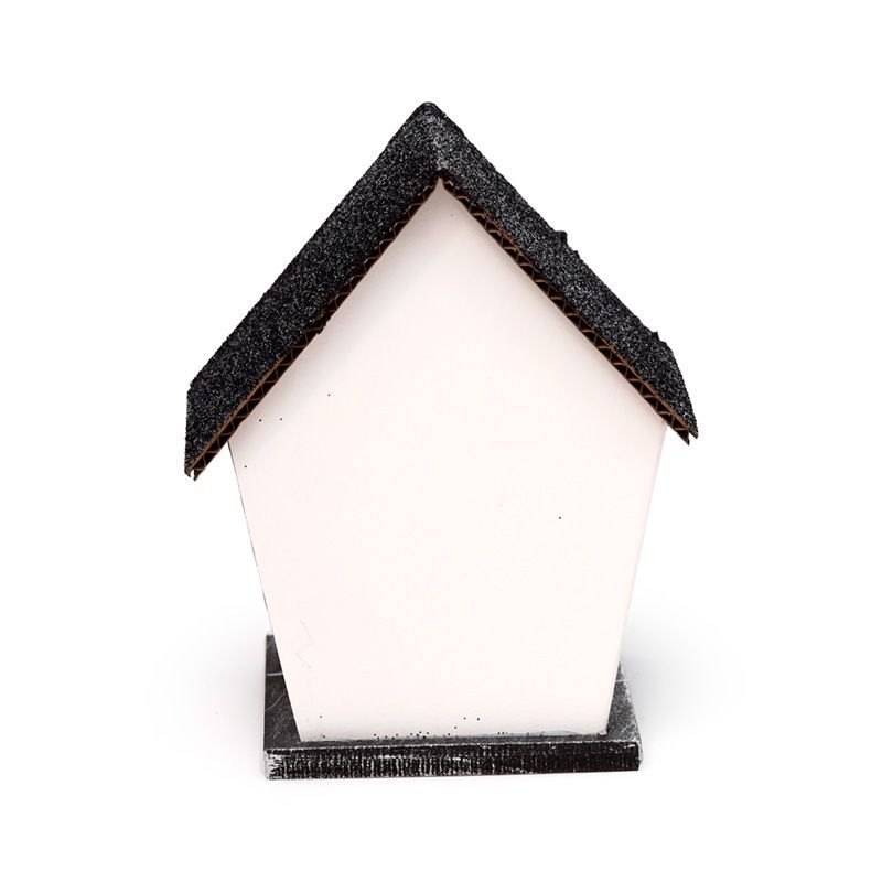 Small white haunted house with glittery black roof, spider web windows and warm LED glow - plain rear view