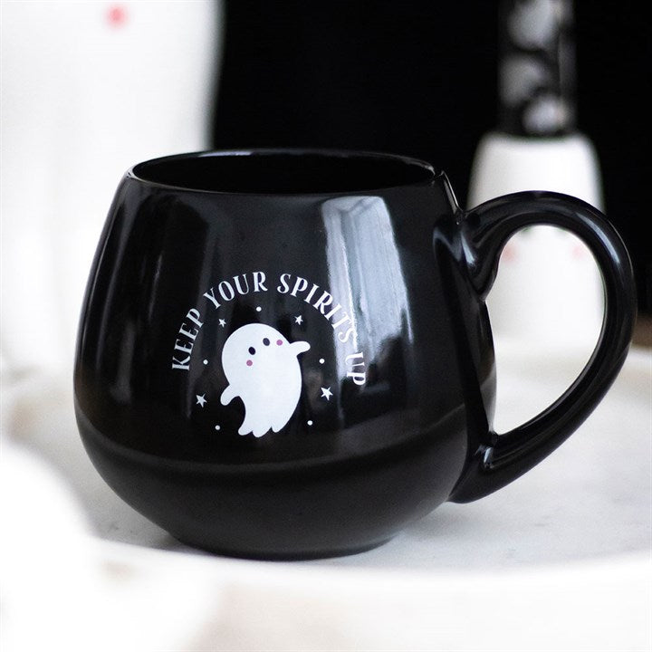 Black mug with a ghost design and text on a white background