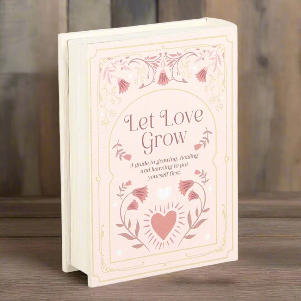 Faux book storage box 'Let love grow' pale pink on a wooden table - fae cottage
