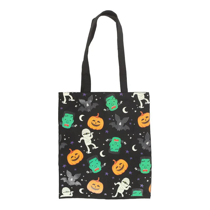Tote bag with Halloween-themed design featuring pumpkins, ghosts, and bats on a black background.