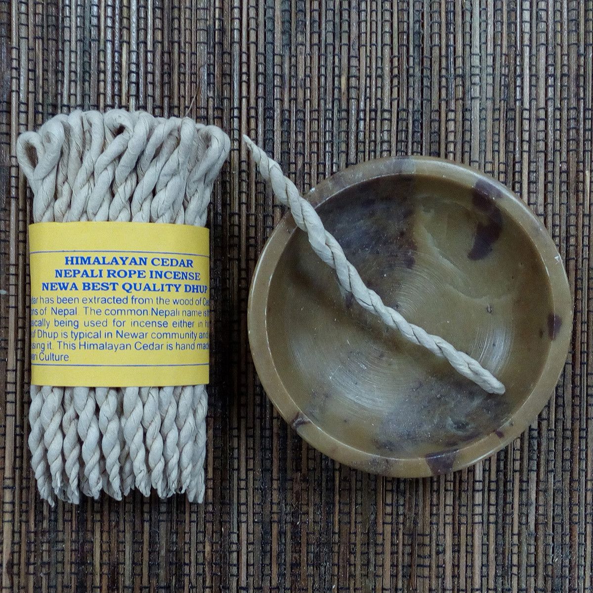 Himalayan Cedar Nepali rope incense with packaging on a woven mat