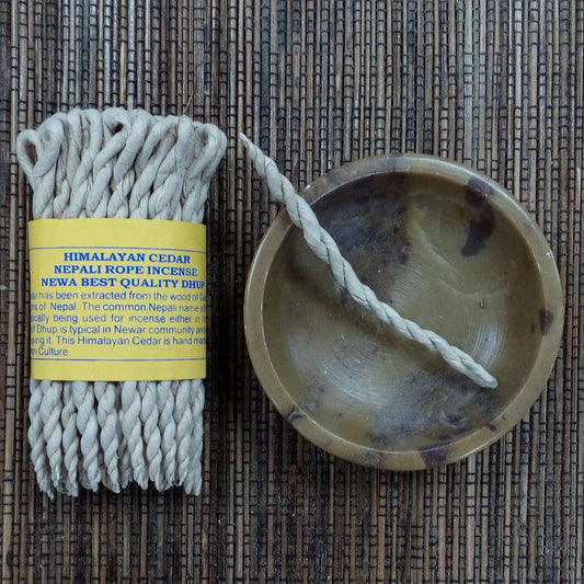 Himalayan Cedar Nepali rope incense with packaging on a woven mat