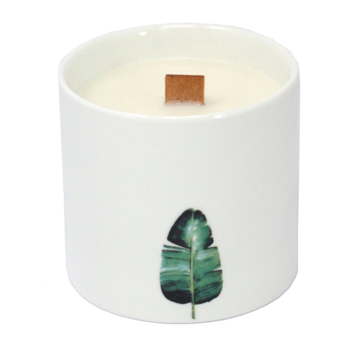 Candle in a white container with a green leaf design on a white background