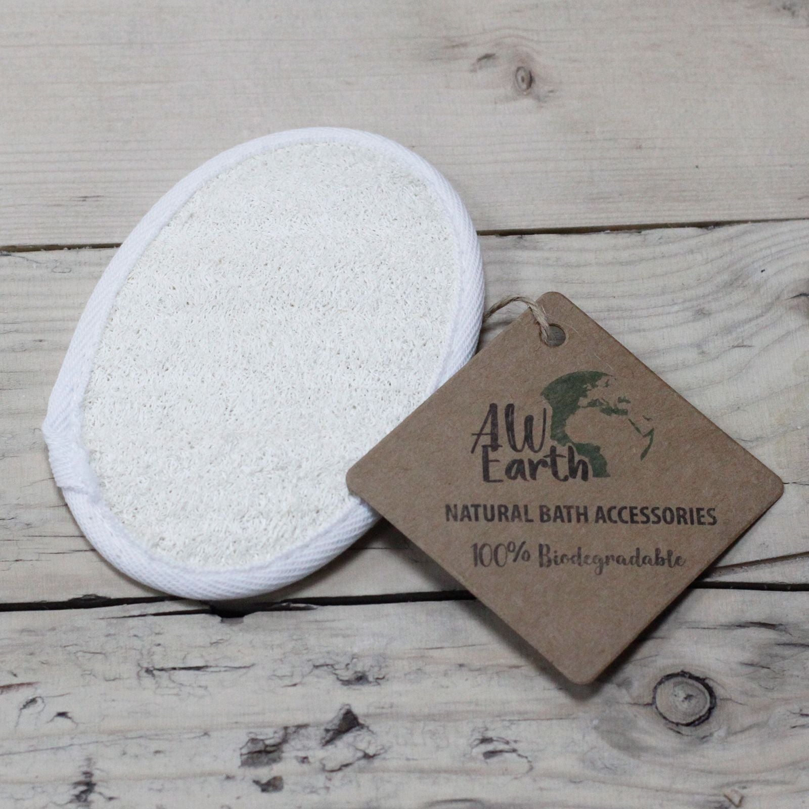 White reusable makeup pad with a 'AWEarth' tag on a wooden surface