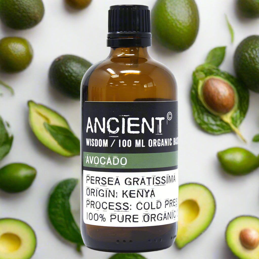 Amber glass bottle with black cap labeled ‘Avocado—100 ml organic base oil’; cold-pressed avocado oil from Kenya, green-gold and richly emollient