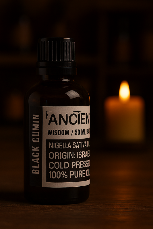 Amber glass bottle with black cap labelled ‘Black Cumin—cold-pressed’; a dark amber-brown Nigella sativa seed oil from Israel with an earthy-spicy scent and a smooth, medium-to-heavy glide for face, body and scalp blends.