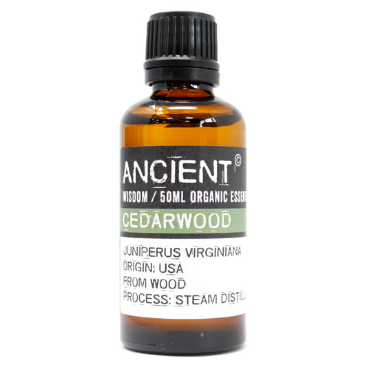 Amber 50 ml bottle labelled ‘Cedarwood—organic, steam-distilled’, a warm woody essential oil for grounding diffusers and DIY room sprays.