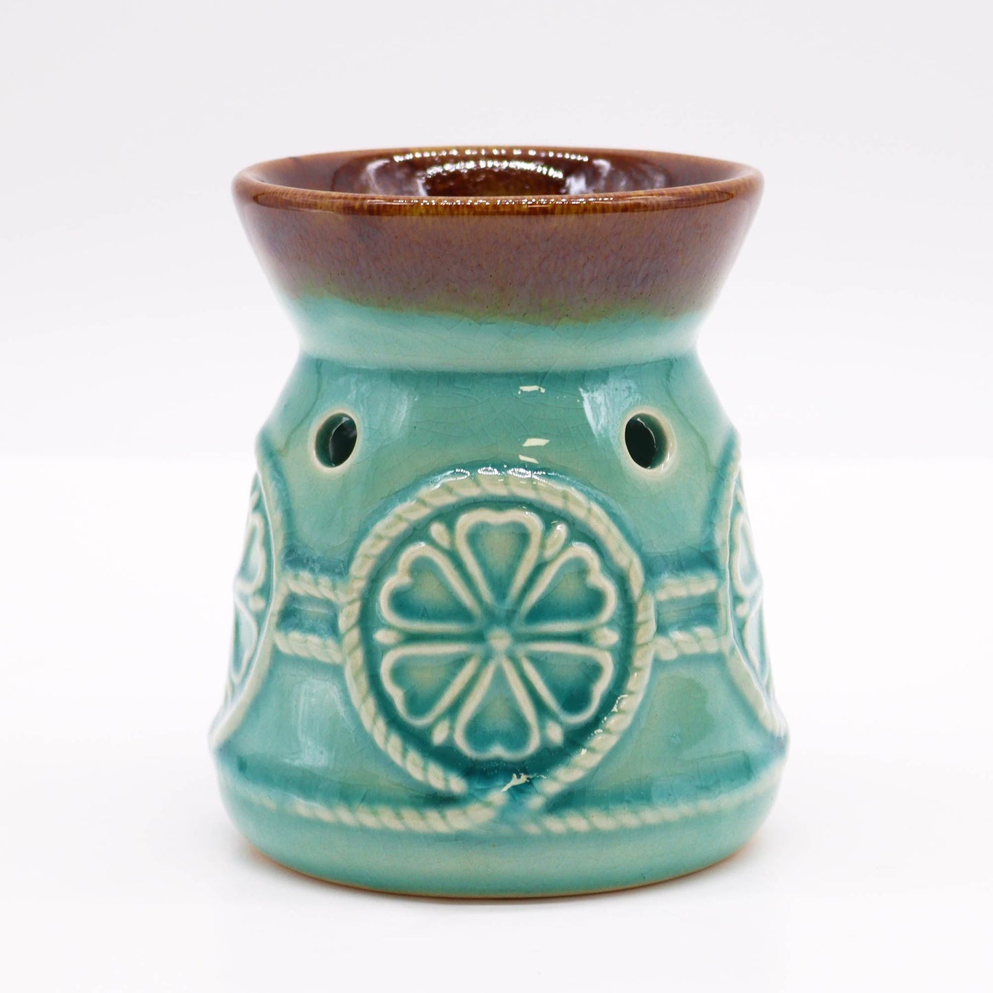 Front studio view of the turquoise glazed burner with warm brown rim and circular rosette design.