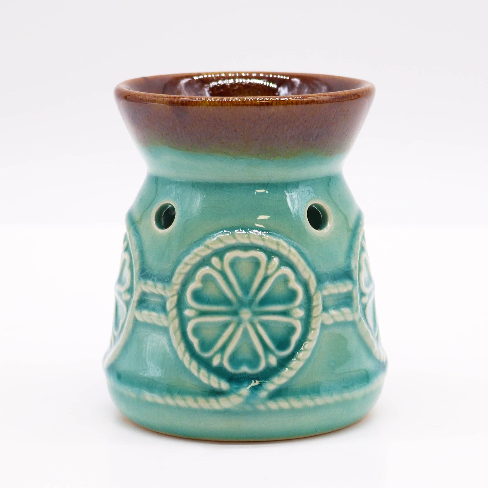 Front studio view of the turquoise glazed burner with warm brown rim and circular rosette design.