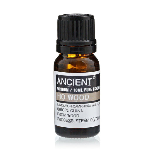 Amber 10 ml bottle labelled ‘Ho Wood—pure essential oil’, steam-distilled from Chinese camphor wood, with a soft, sweet-woody aroma known for relaxation and skin renewal
