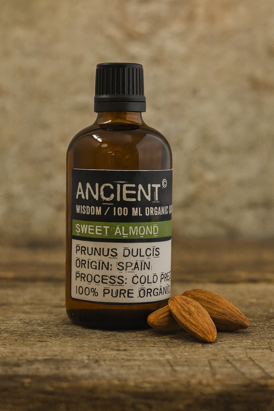 Amber glass bottle with black cap labelled ‘Sweet Almond—organic, cold-pressed’; a pale yellow, nearly scentless carrier oil ideal for massage and everyday skincare.