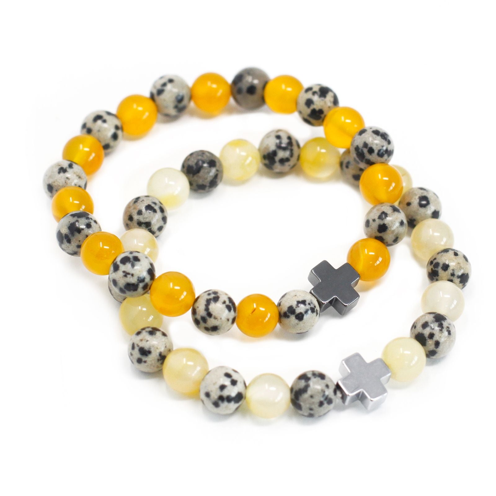 Close-up of beaded bracelets showing yellow agate, spotted Dalmatian jasper, and hematite cross charms.