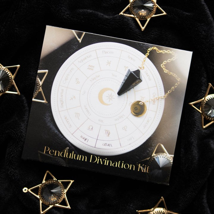 Pendulum Divination Kit with astrological chart and pendulum on a black background