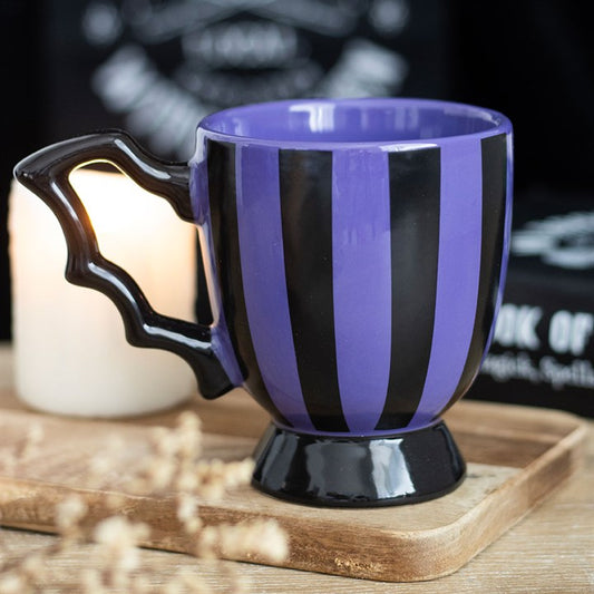 black and purple striped mug with a bat wing handle.