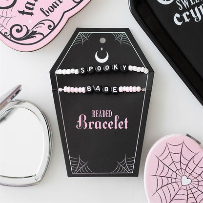2 bracelets saying spooky and babe on a black coffin card holder