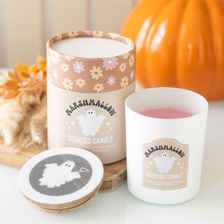 Marshmallow scented candle with packaging and coaster on a table