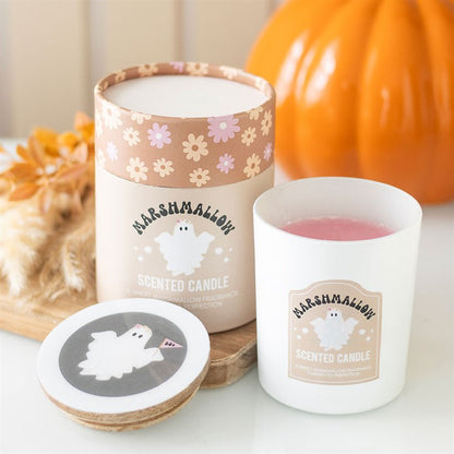 Marshmallow scented candle with packaging and coaster on a table