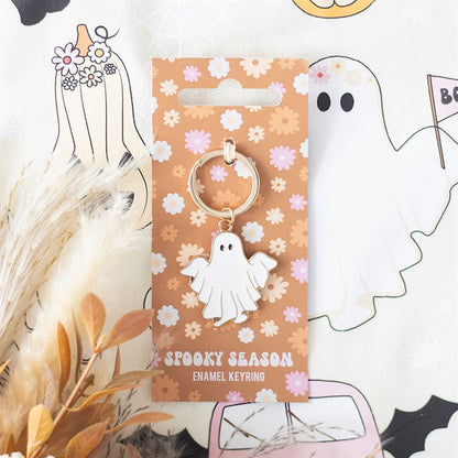 Spooky season enamel keyring on a decorative card with floral patterns.