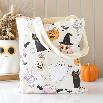 Tote bag with Halloween-themed design featuring cats, ghosts, and pumpkins on a neutral background.