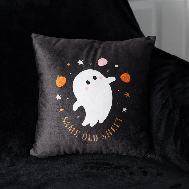 Black pillow with a ghost design and text on a dark background