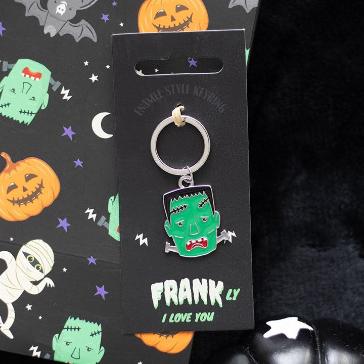 Halloween-themed keychain with 'Frankly I Love You' text on a black card with cartoon characters.