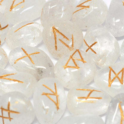 Close-up of white stones with orange runes on a white background