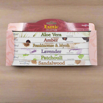 Pack of Exotic Collection incense sticks with various scents on a wooden background