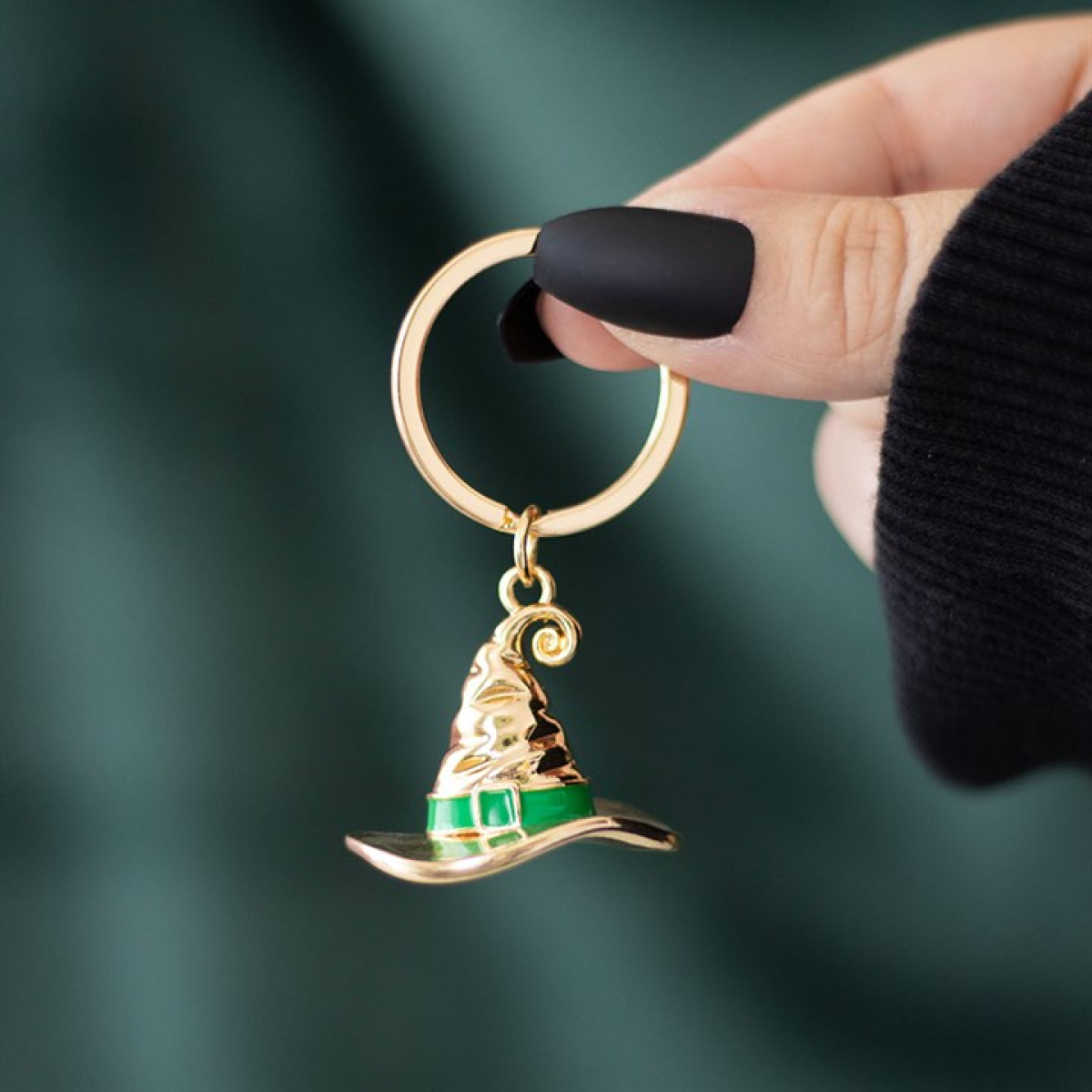 Gold-tone witch hat keyring with green enamel band on a split ring