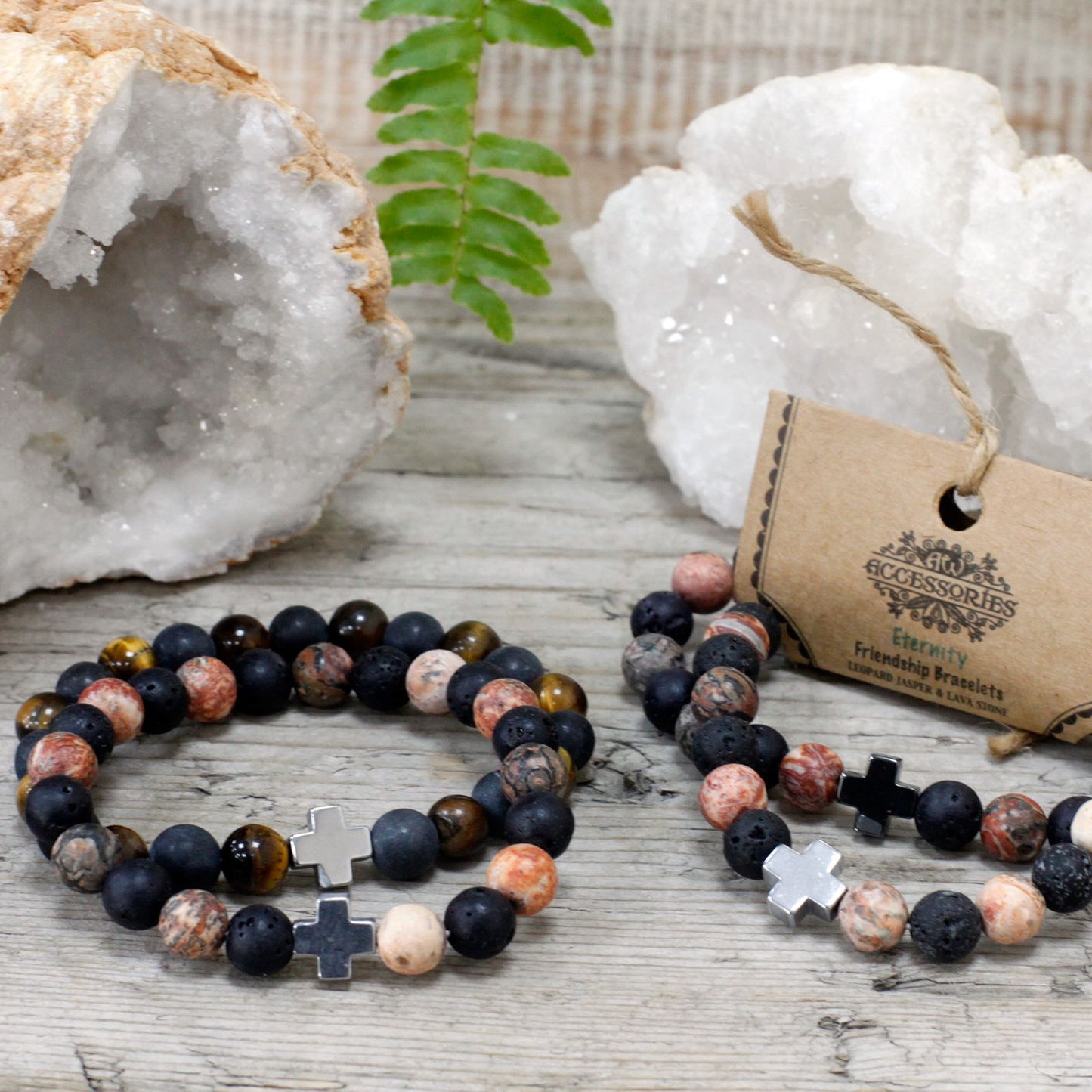 Pair of Leopard Skin Jasper and Lava Stone friendship bracelets styled beside crystal geodes on a wooden surface.