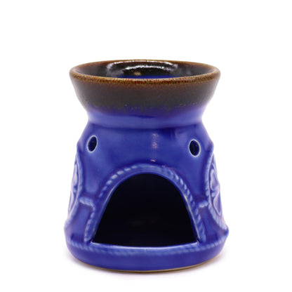 Front view of blue oil burner showing arched tealight opening.