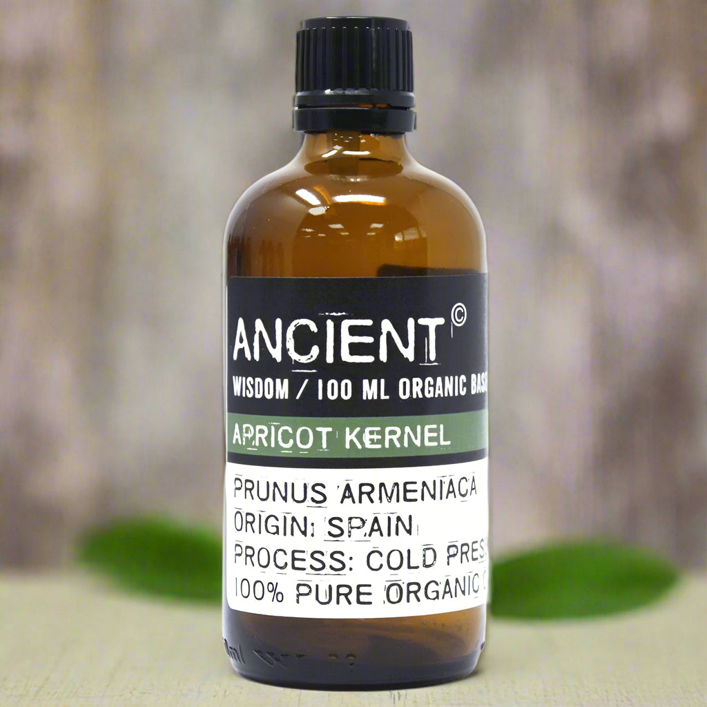 Amber glass bottle with black cap labelled ‘Apricot Kernel—organic, cold-pressed’; a pale yellow, fast-absorbing carrier oil from Spain.