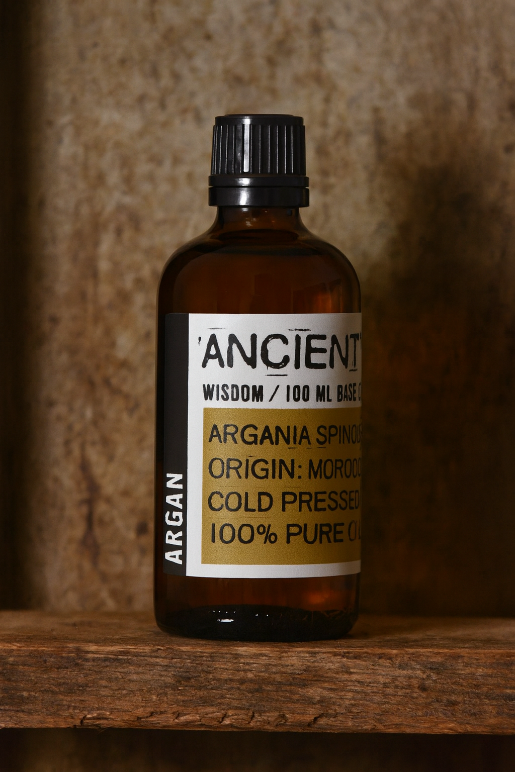 Amber glass bottle with black cap labelled ‘Argan—cold-pressed’; light golden oil from Morocco with a mild, nutty aroma.