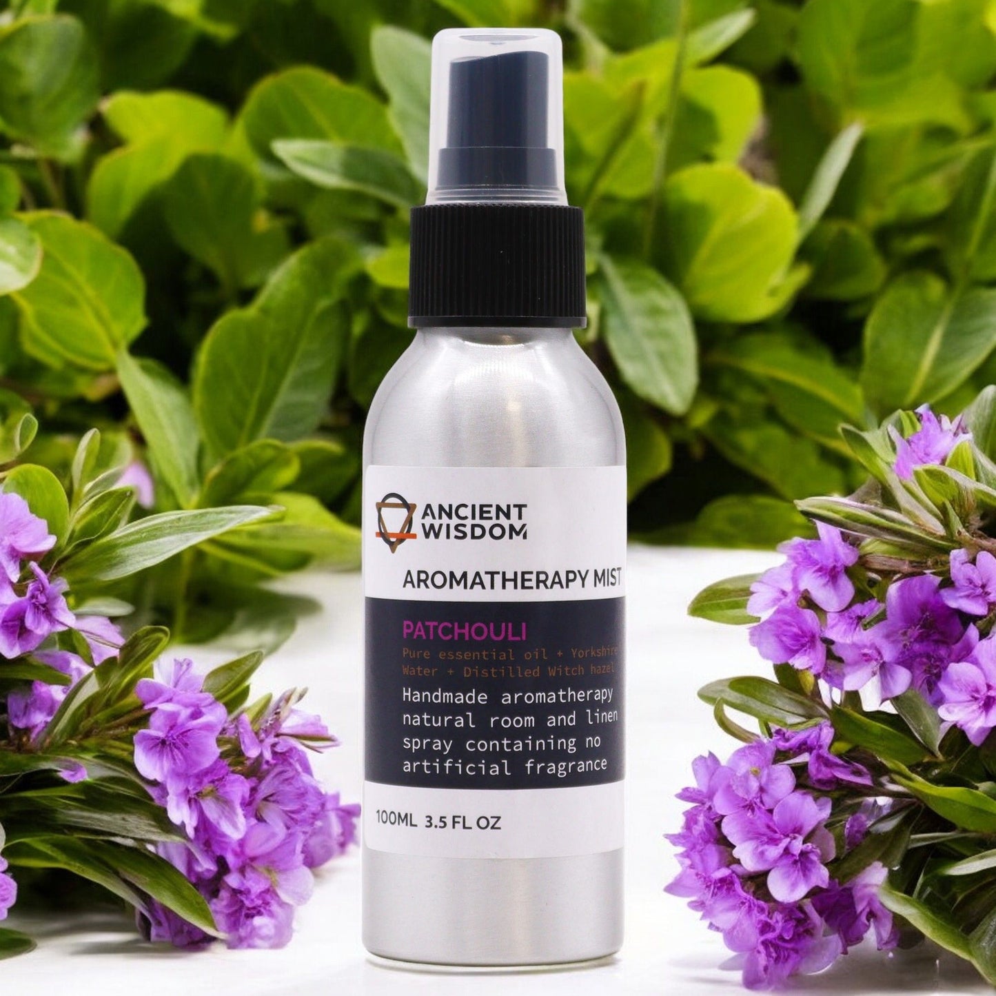 Brushed-aluminium spray bottle with black atomiser labelled ‘Aromatherapy Mist—Patchouli’; a natural room and linen spray made with Yorkshire water, distilled witch hazel and patchouli essential oil.