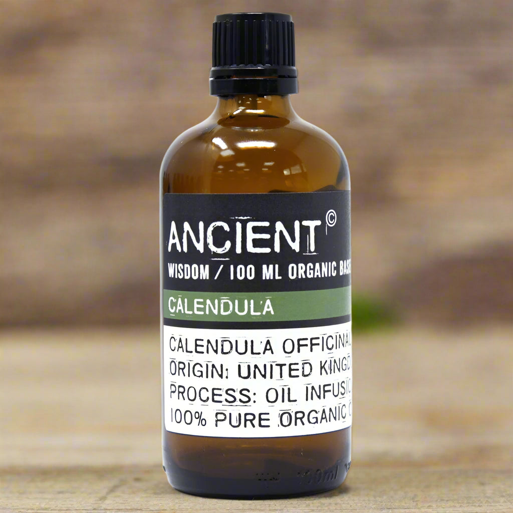 Amber glass bottle with black cap labelled ‘Calendula—oil infusion’; a golden organic macerate of Calendula officinalis petals in sunflower seed oil from United Kingdom