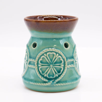 Front studio view of the turquoise glazed burner with warm brown rim and circular rosette design.