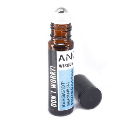 Small amber roller bottle with stainless steel ball and black cap, ‘Don’t Worry!’ label listing bergamot, geranium and frankincense—pre-diluted aromatherapy roll-on for wrists, temples and neck. Cap off.