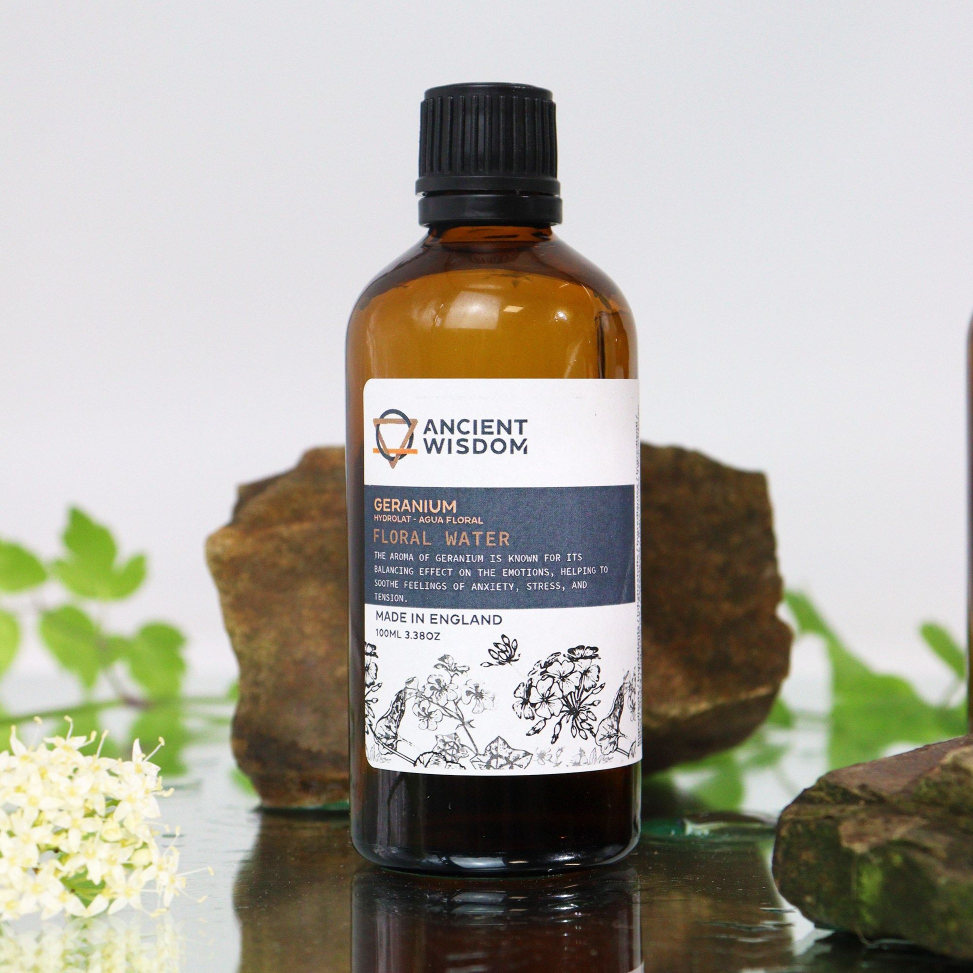 Amber glass bottle with black screw cap labelled ‘Geranium Floral Water’—a clear steam-distilled hydrolat for toning, mists, and DIY skincare.