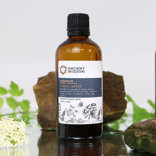 Amber glass bottle with black screw cap labelled ‘Geranium Floral Water’—a clear steam-distilled hydrolat for toning, mists, and DIY skincare.