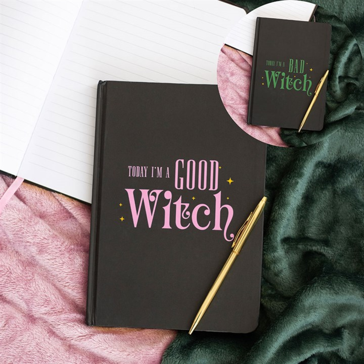 Black notebook with 'Today I'm a Good Witch' text on a pink surface with a gold pen.