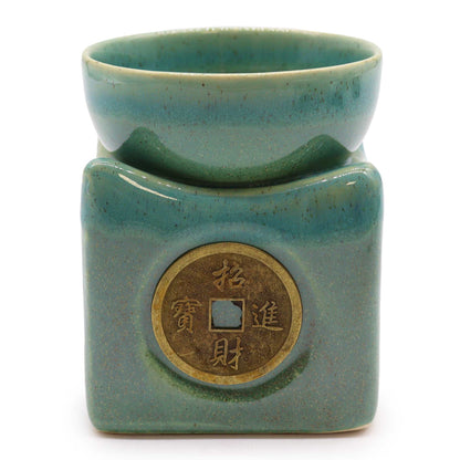 front view highlighting the brass-toned lucky coin and smooth jade glaze.