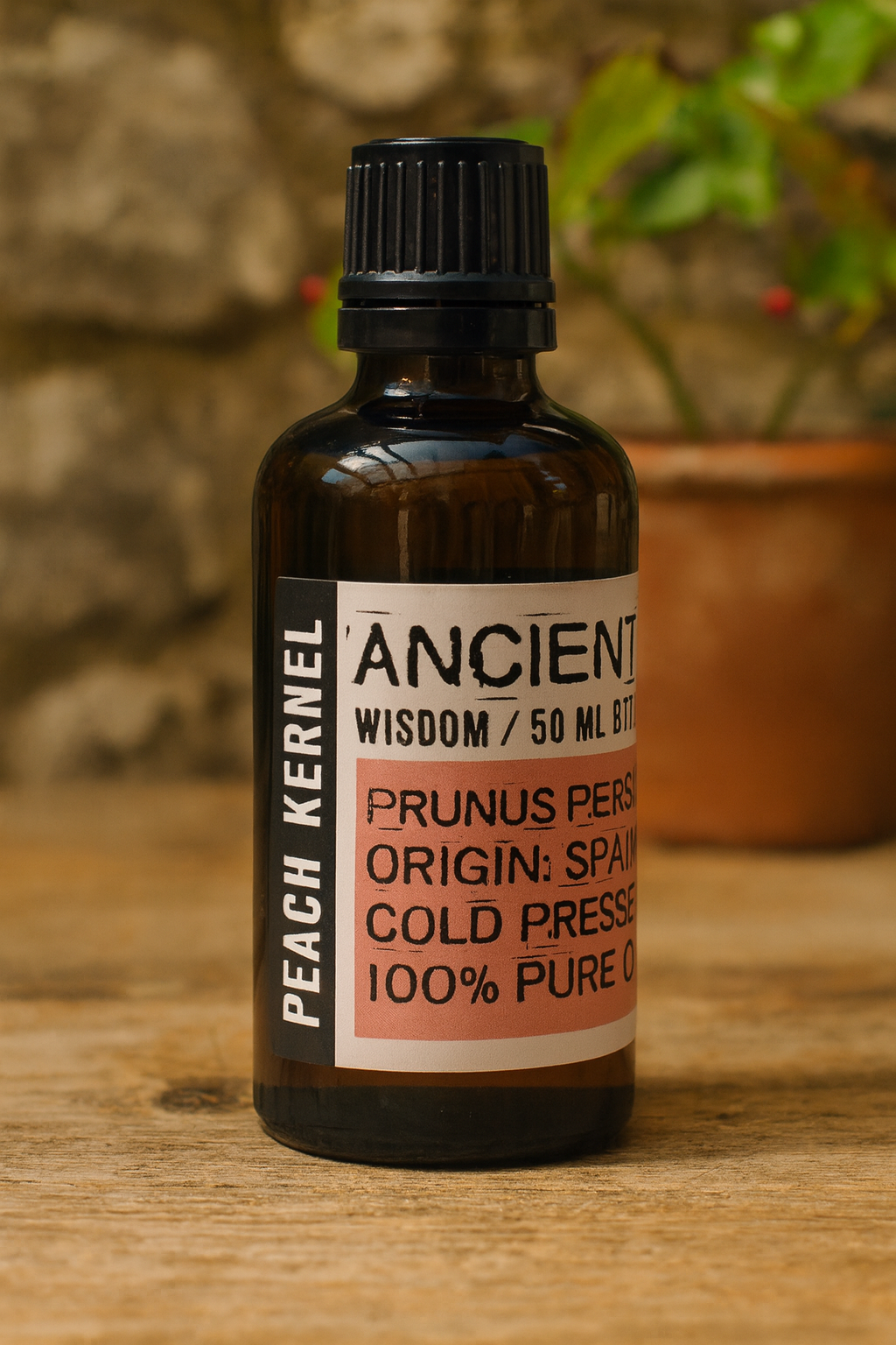 Amber glass bottle with black cap labelled ‘Peach Kernel—cold-pressed’; a clear, light-yellow Prunus persica kernel oil from Spain with a delicate aroma and fast-absorbing, silky finish for face and body blends.
