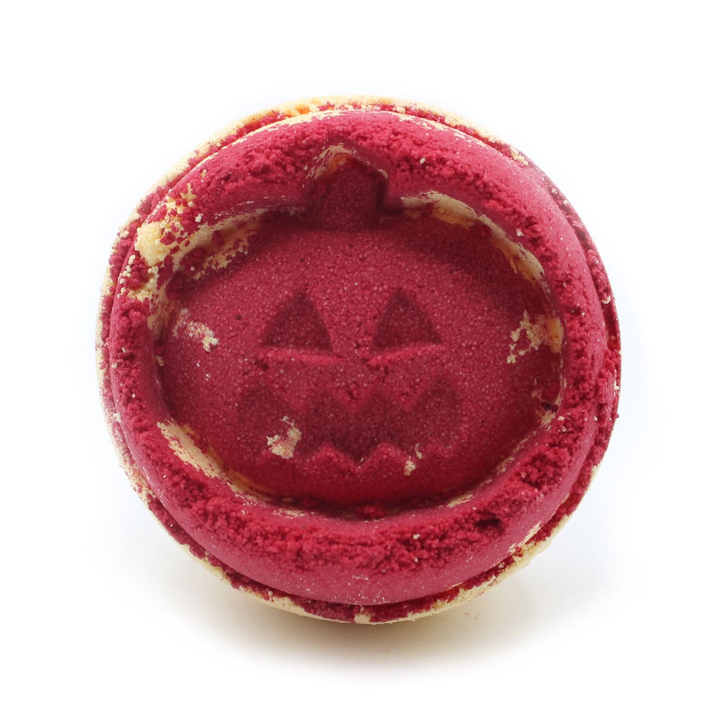 Close-up of a red jack-o’-lantern pumpkin bath bomb, handmade in the UK with aniseed fragrance.