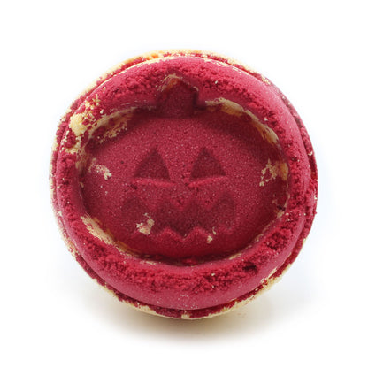 Close-up of a red jack-o’-lantern pumpkin bath bomb, handmade in the UK with aniseed fragrance.