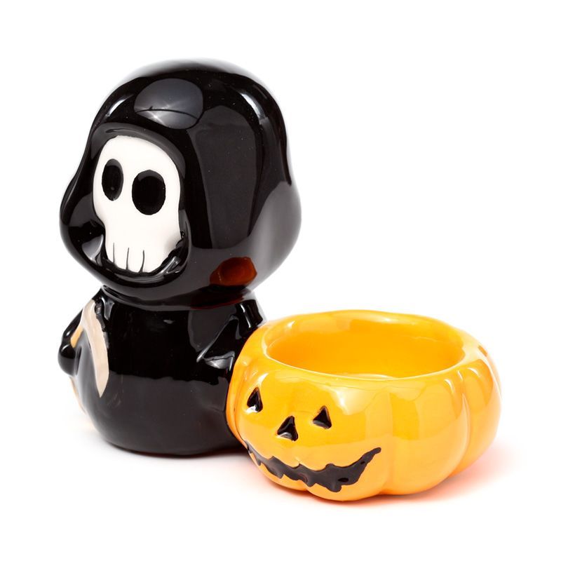 Glossy black Skull Boy with jack-o’-lantern bowl, front three-quarter view.