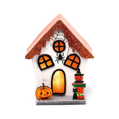 Front view of pumpkin house LED decoration with orange scalloped roof, spider web and pumpkins.