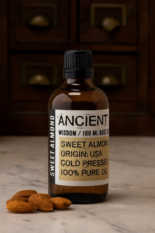 Amber glass bottle with black cap labelled ‘Sweet Almond—cold-pressed’; a pale yellow, nearly odourless Prunus amygdalus dulcis oil from the USA with a very light, silky glide for face, body and massage blends.