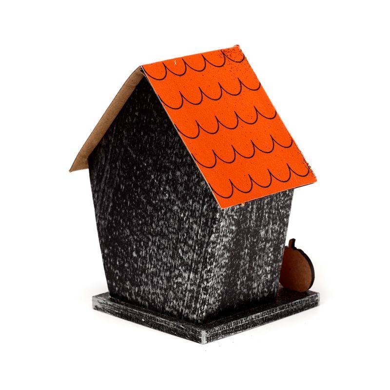 Back of the Halloween pumpkin house showing orange roof and black wood-effect walls on a square base.