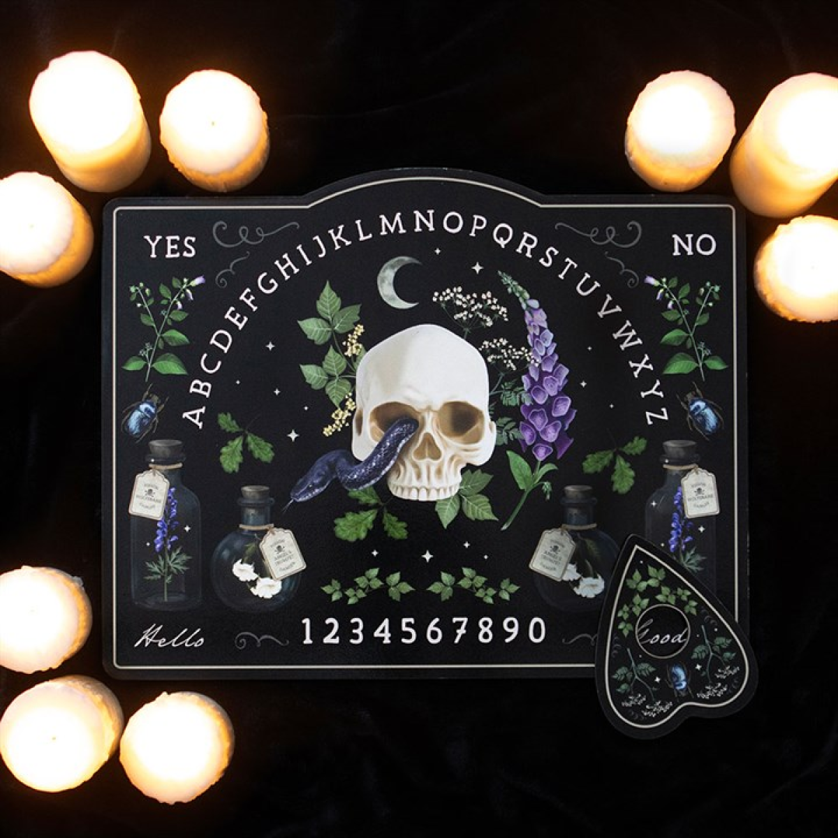 Black talking board featuring skull, foxglove and potion bottles with a matching planchette; moody candlelit, botanical aesthetic.