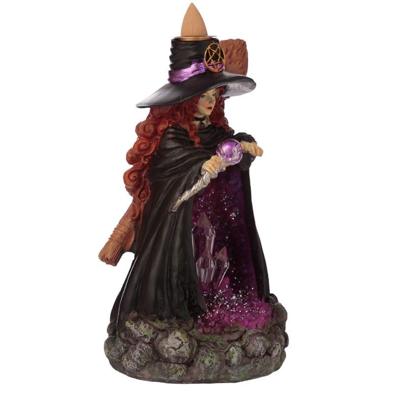 Angled view of witch figurine backflow burner with staff, broom and purple geode detail.
