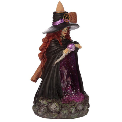 Angled view of witch figurine backflow burner with staff, broom and purple geode detail.
